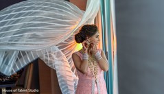 Indian bride putting earrings on. Indian bride putting earrings on.