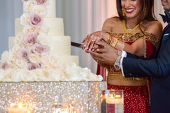 Cheerful Indian bride and groom cutting the cake. Cheerful Indian bride and groom cutting the cake.