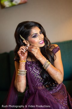 Enchanting Indian bride putting her earrings on. Enchanting Indian bride putting her earrings on.