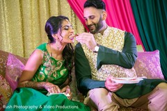 Sweet Indian couple eating at their pre-wedding celebration. Sweet Indian couple eating at their pre-wedding celebration.