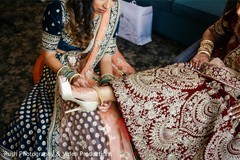 Indian bride being helped getting ready. Indian bride being helped getting ready.