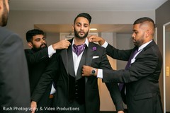 Indian groom being helped by groomsmen. Indian groom being helped by groomsmen.