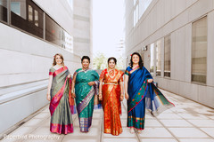 Indian bride and bridesmaids posing for an outdoor photo. Indian bride and bridesmaids posing for an outdoor photo.