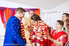 Indian groom putting flower garland to bride. Indian groom putting flower garland to bride.