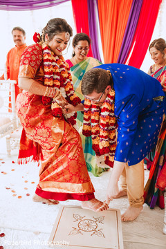 Indian groom putting toe ring to bride at ceremony. Indian groom putting toe ring to bride at ceremony.