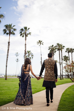Indian groom and bride walking outdoors. Indian groom and bride walking outdoors.