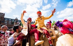 Indian groom being lifted up during baraat Indian groom being lifted up during baraat