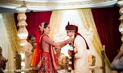 Indian bride putting flower garland to groom Indian bride putting flower garland to groom