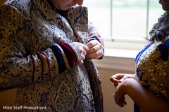 Indian groom putting his reception sherwani. Indian groom putting his reception sherwani.