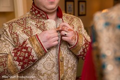 Handsome indian groom putting his sherwani. Handsome indian groom putting his sherwani.