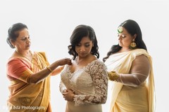 Maharani getting help with her wedding dress. Maharani getting help with her wedding dress.