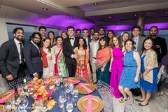 Indian couple posing with guests at reception party. Indian couple posing with guests at reception party.