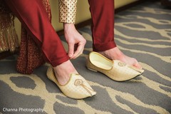 Indian groom putting his ceremony shoes on. Indian groom putting his ceremony shoes on.