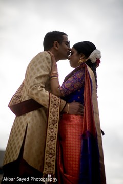 Indian groom kissing the bride to be Indian groom kissing the bride to be
