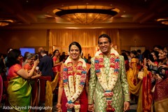 Indian bride and groom walking out from their ceremony Indian bride and groom walking out from their ceremony