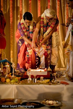 Indian couple making offerings to sacred fire Indian couple making offerings to sacred fire