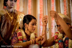 Indian groom offers her lifelong protection with the sacred necklace Indian groom offers her lifelong protection with the sacred necklace