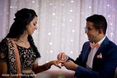 Indian groom putting wedding ring to bride Indian groom putting wedding ring to bride