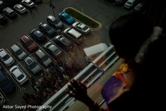 Lovely indian bride looking baraat out the window Lovely indian bride looking baraat out the window