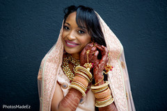 Indian bride putting earrings on Indian bride putting earrings on