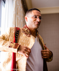 Indian groom getting his sherwani on. Indian groom getting his sherwani on.