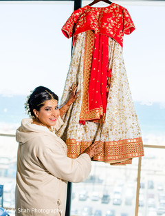 Maharani posing next to her ceremony lehenga. Maharani posing next to her ceremony lehenga.