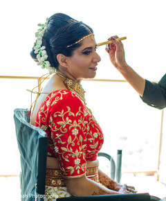 Lovely indian bride getting her hair and makeup. Lovely indian bride getting her hair and makeup.