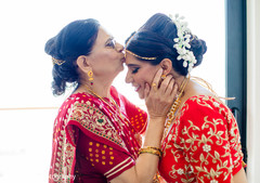 Sweet Indian bride being kiss by mother. Sweet Indian bride being kiss by mother.