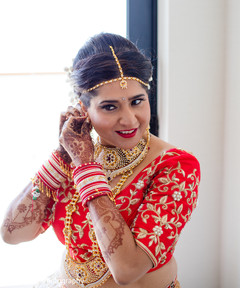 Marvelous Indian bride putting her earrings on. Marvelous Indian bride putting her earrings on.