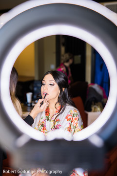 Indian bride getting her wedding makeup done Indian bride getting her wedding makeup done