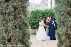 Bridesmaid helping bride to get ready Bridesmaid helping bride to get ready