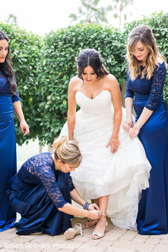 Sweet indian bride's bridemaid helping her to get ready Sweet indian bride's bridemaid helping her to get ready