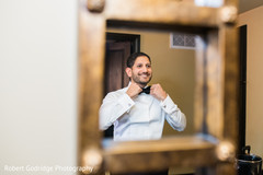 Charming indian groom looking in the mirror Charming indian groom looking in the mirror