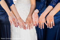 Beautiful indian bride and bridesmaid showing henna art Beautiful indian bride and bridesmaid showing henna art