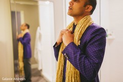 Indian groom getting his wedding outfit on. Indian groom getting his wedding outfit on.