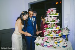 Incredible Indian couple cutting cake capture. Incredible Indian couple cutting cake capture.