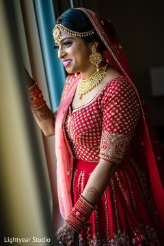 Lovely indian bride looking out the baraat celebration Lovely indian bride looking out the baraat celebration