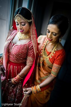 Indian bride being helped with her wedding veil Indian bride being helped with her wedding veil