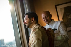 Indian groom being helped by parents to get ready Indian groom being helped by parents to get ready