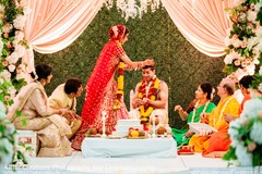 Indian bride putting rice on to grooms head ritual. Indian bride putting rice on to grooms head ritual.