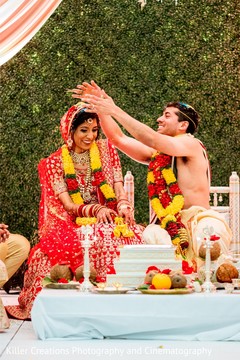 Indian bride getting rice on her head by groom. Indian bride getting rice on her head by groom.