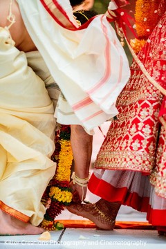 Indian couple when stepping on nuts with toes ritual. Indian couple when stepping on nuts with toes ritual.