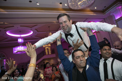 Indian groom being lifted up during reception party Indian groom being lifted up during reception party