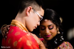 Indian bride and groom being hugged Indian bride and groom being hugged