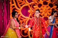 Indian bride and groom joyfully dancing Indian bride and groom joyfully dancing