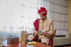Joyful Indian groom reading bridal card. Joyful Indian groom reading bridal card.