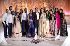 Indian couple posing with bridesmaids and groomsmen at reception. Indian couple posing with bridesmaids and groomsmen at reception.