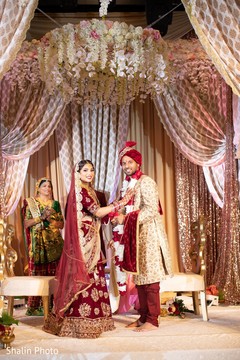 Indian bride putting flower garland to groom. Indian bride putting flower garland to groom.