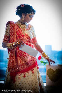 Sweet indian bride reading groom's card Sweet indian bride reading groom's card