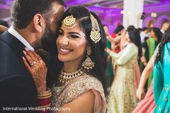 Romantic Indian groom talking to his Maharani's ear. Romantic Indian groom talking to his Maharani's ear.